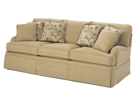beige couch with matching pillow and floral accent pillows