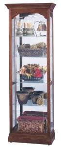 howard miller curio cabinet with flowers, flower pots, baskets, and candles inside
