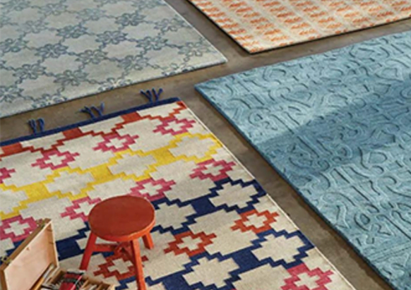 4 different rugs of different colors and patterns