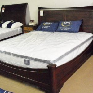 dark wood sleigh bed frame with serta mattress and pillows