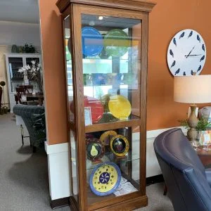 Wooden Curio showing colorful plates on stands