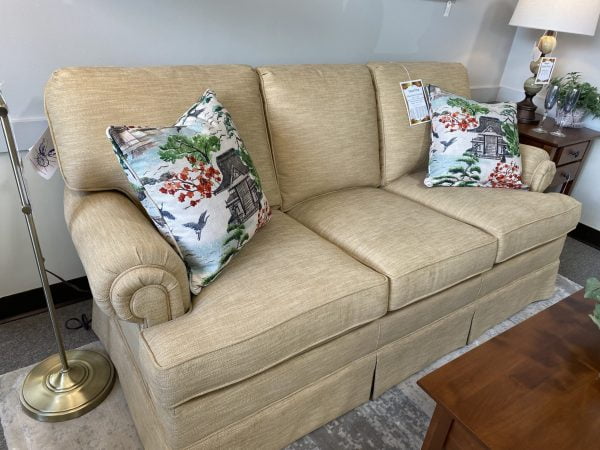 light brown couch with two accent pillows