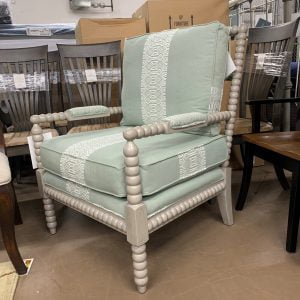 Gray armchair with light green and white cushions