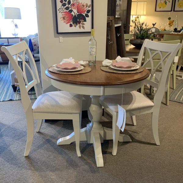 round table with 2 white chairs