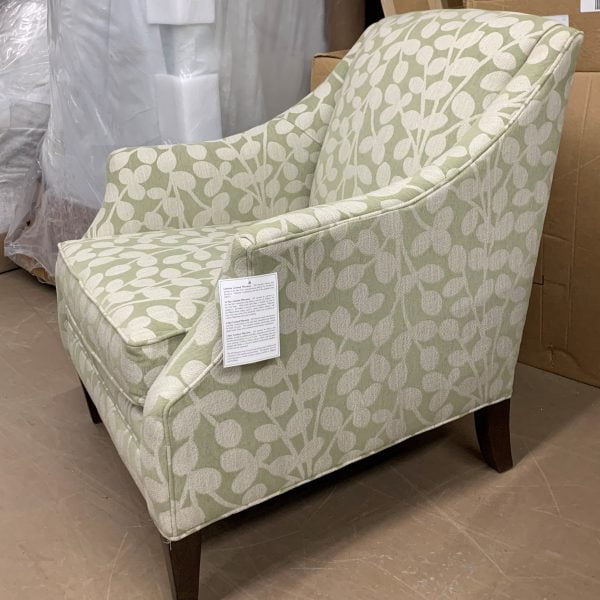 Sage green and tan patterned fabric armchair with dark brown wooden legs