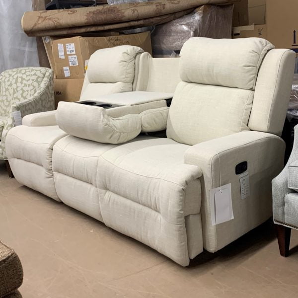 Off white fabric couch that has attached recliners