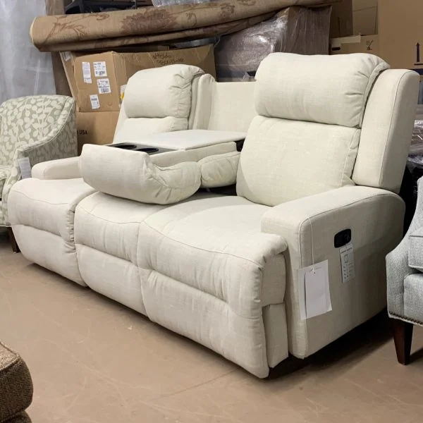 Off white fabric couch that has attached recliners